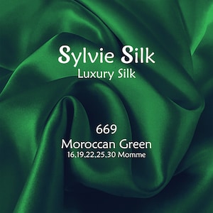May include: A close-up of a deep green silk fabric with the text "Sylvie Silk Luxury Silk 669 Moroccan Green 16,19,22,25,30 Momme" printed on it.