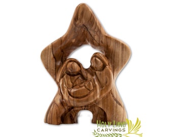 May include: A wooden carving of the Holy Family in a star shape. The carving is made of olive wood and features the Virgin Mary, Joseph, and baby Jesus.