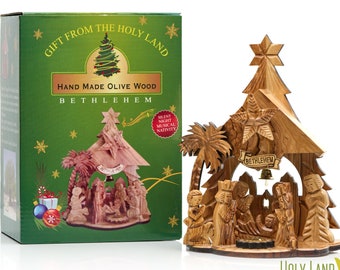May include: A hand-carved olive wood nativity scene from Bethlehem, featuring the Holy Family, angels, and a star on top of a Christmas tree. The scene is in a box with the words "Gift from the Holy Land" and "Hand Made Olive Wood Bethlehem".