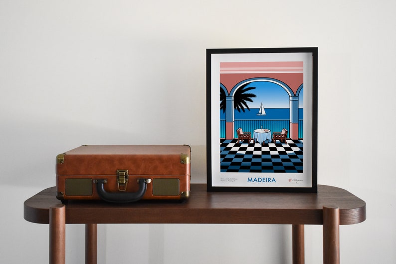 Colourful giclee art print of the view from Belmond Reids Palace hotel bar in Funchal, Madeira. The view from the bar shows palm trees, the sea, and a sailing boat. The main colours are pink, blue, black and white. The print comes in 4 sizes.