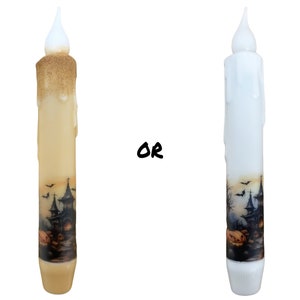 May include: Two Halloween-themed LED candles. One is ivory with gold glitter, the other is white. Both have a spooky haunted house and pumpkin design. The candles have a realistic flickering flame effect, perfect for Halloween decor.