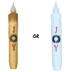 May include: Two battery-operated LED candles with a "JOY" design and a red and green wreath. The candle on the left is a cream color and the candle on the right is white.