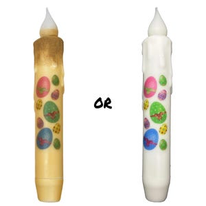 May include: Two Easter-themed candles, one with a yellow wax base and the other with a white wax base. Both candles have a drippy wax design and feature colorful Easter egg stickers.