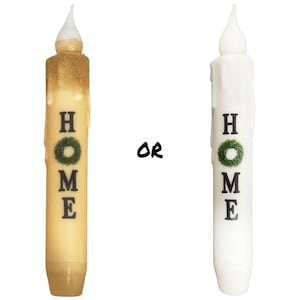 May include: Two battery-operated LED candles with a "HOME" design. One candle is gold and the other is white.