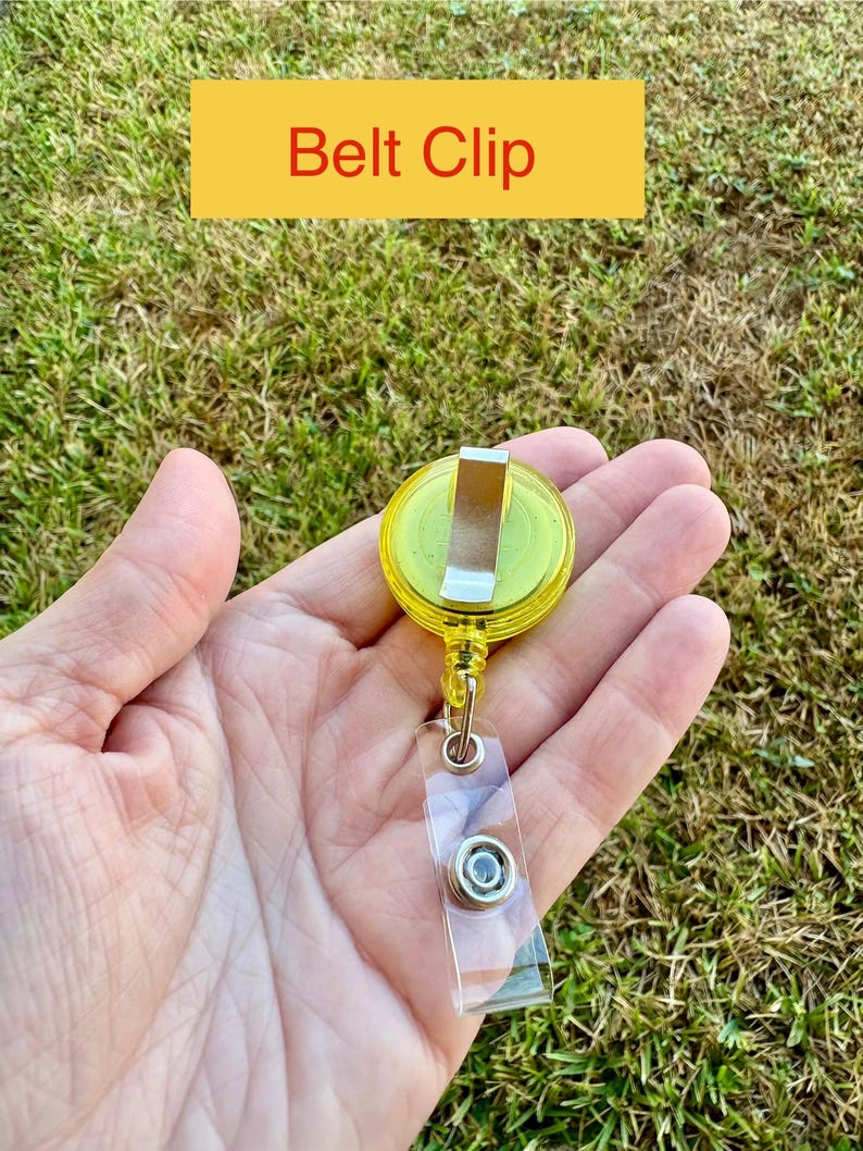May include: A yellow belt clip with a silver metal clip and a clear plastic strap. The text "Belt Clip" is displayed on a yellow rectangle above the clip.