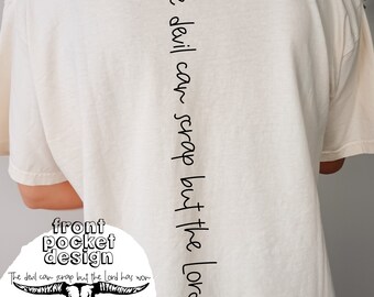 May include: A white t-shirt with the text "The devil can scrap but the Lord has won" printed vertically down the back. The front of the shirt features a skull with horns and the text "front pocket design" and "The devil can scrap but the Lord has won".