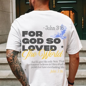May include: White t-shirt with a black and yellow graphic that says "For God So Loved The World" with a blue bird graphic and the text "John 3:16" above and below the graphic.