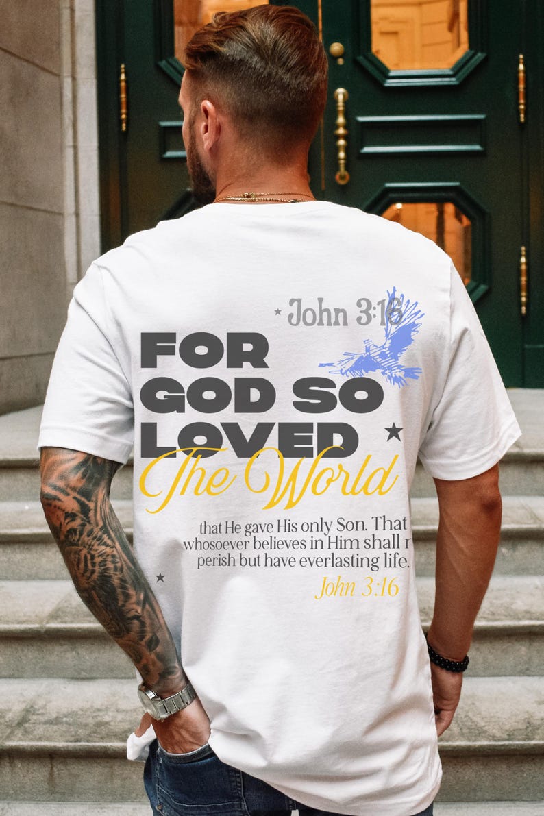 May include: White t-shirt with a black and yellow graphic that says "For God So Loved The World" with a blue bird graphic and the text "John 3:16" above and below the graphic.