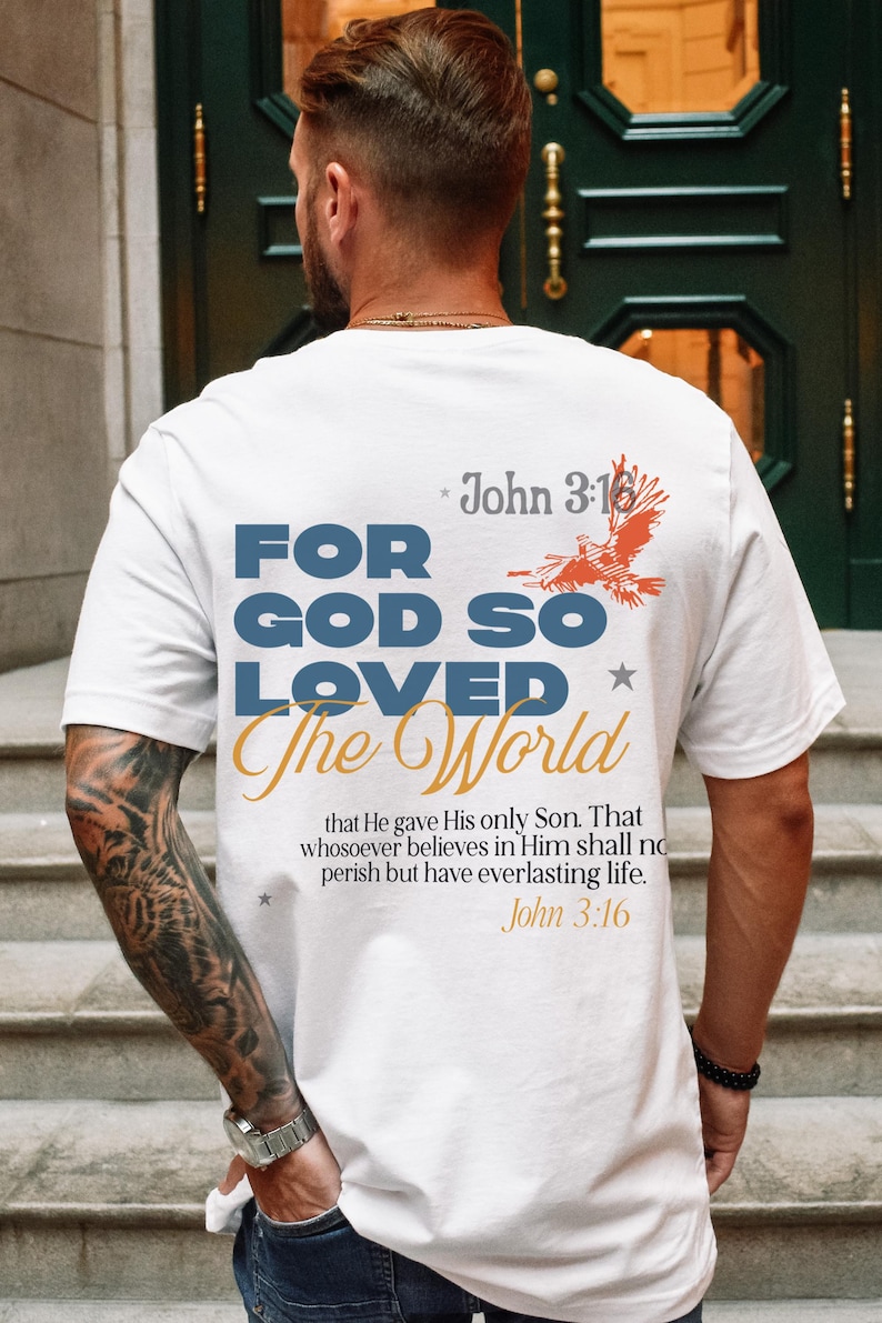 May include: White t-shirt with a blue and orange graphic that says "For God So Loved The World" with a bird design and the text "John 3:16" above and below the graphic.