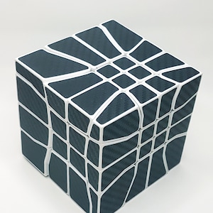 May include: A black and white 3x3 cube puzzle with a unique geometric design. The cube is made of plastic and has a carbon fiber pattern.