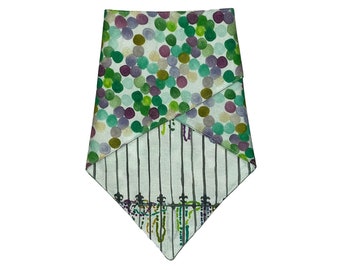 May include: A green and purple patterned bandana with a white and black striped section and a black metal gate design.