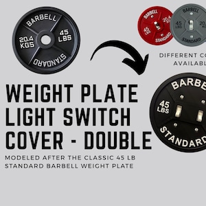 May include: Black weight plate light switch cover with white lettering. The cover is modeled after a 45 lb barbell weight plate, with the text "BARBELL", "45 LBS", and "20.4 KGS". Different colors are available.