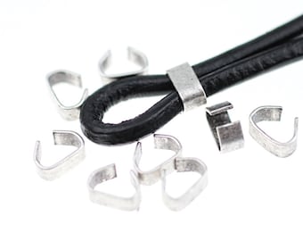 May include: Silver metal clasps for leather cord or strap. The clasps are in the shape of a loop with a small hook. There are 10 clasps in the image.