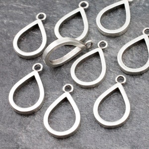 May include: Nine silver teardrop-shaped pendant charms with a smooth, polished finish. Each charm has a small loop at the top for attaching to jewelry.