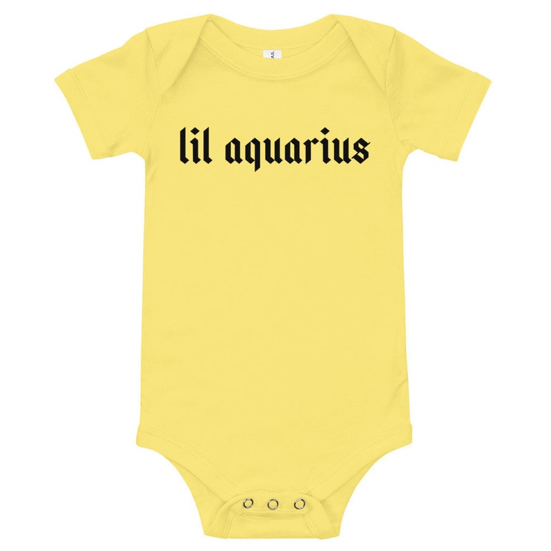May include: Yellow baby onesie with black text that reads "lil aquarius".