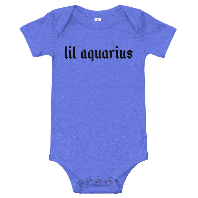 May include: A blue baby onesie with short sleeves and black text that reads "lil aquarius".