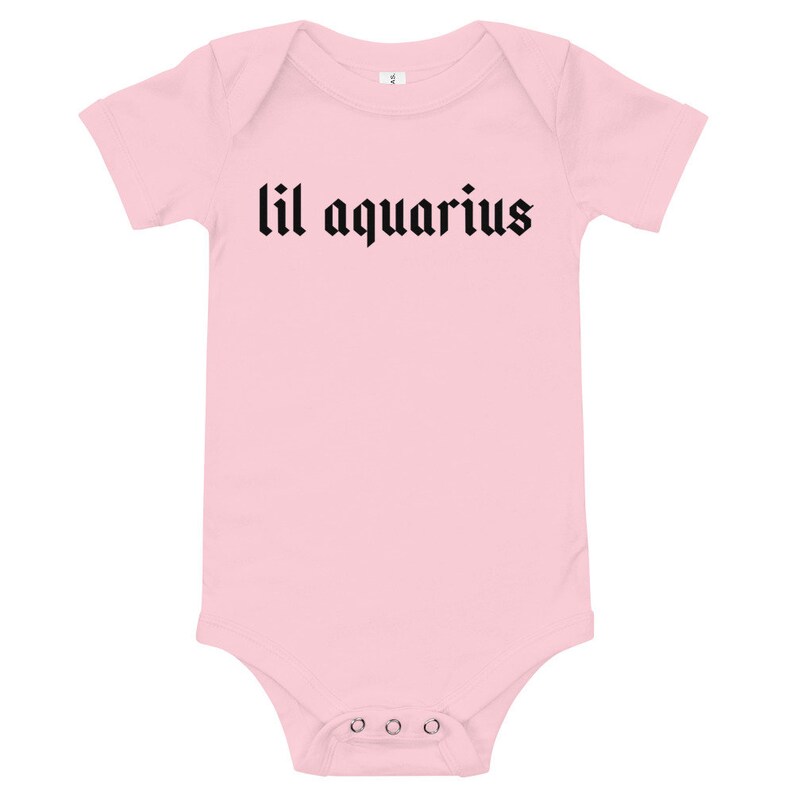 May include: Pink baby onesie with black text that reads "lil aquarius".