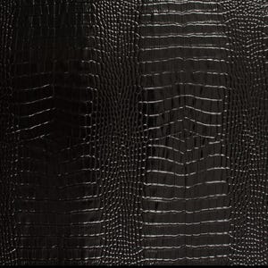 May include: Black crocodile embossed leather texture. The surface has a subtle sheen and a repeating pattern of scales.