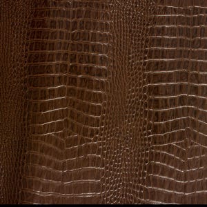 May include: Brown faux leather with a crocodile skin pattern.