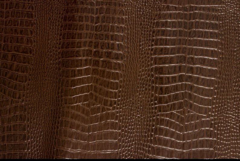 May include: Brown faux leather with a crocodile skin pattern.