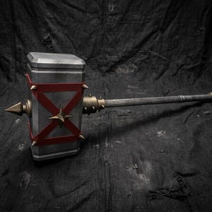 May include: A gray and bronze war hammer with a spiked head and handle. The hammer head is decorated with red straps and a star emblem. The handle is ribbed and the hammer is approximately 30 inches long.