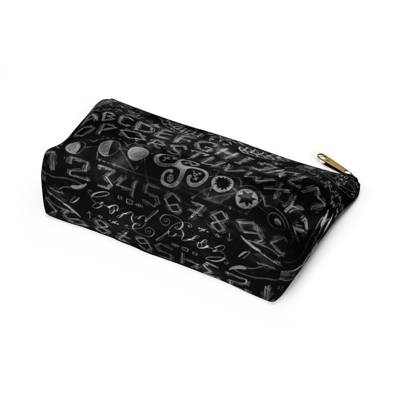 May include: Black zippered pouch with a white design of letters, numbers, and symbols on a black background.