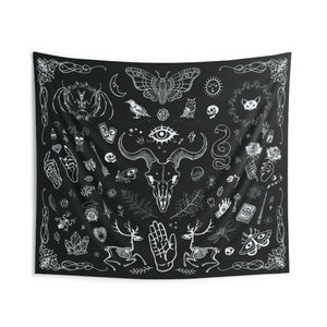 May include: Black and white tapestry with a variety of occult and mystical symbols, including a skull, an eye, a snake, a moth, a deer, and a hand. The tapestry is on a black background.