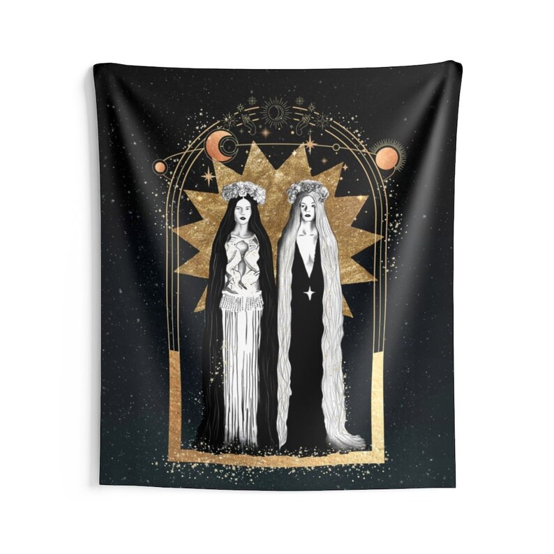 May include: A black tapestry with a gold design featuring two women in white and black robes standing in front of a large gold star. The women are wearing gold crowns and the background is a dark blue with gold stars.