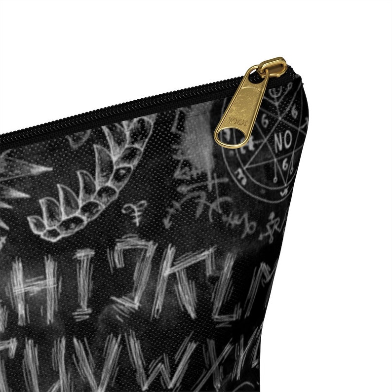 May include: Black zippered pouch with a white and black graphic print of various symbols and text, including "NO" and "WHISKEY".