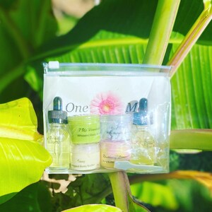 May include: A clear plastic bag containing a set of four small jars and bottles of body care products. The jars and bottles are labeled with the names "7 Up Passionfruit Whipped Body Butter", "Baby Butters", "Icing Whipped Body Butter", and "Raspberry Lemonade Body Butter". There is also a small bottle of "Paradise Body Oil" and a small bottle of "Hair Oil".