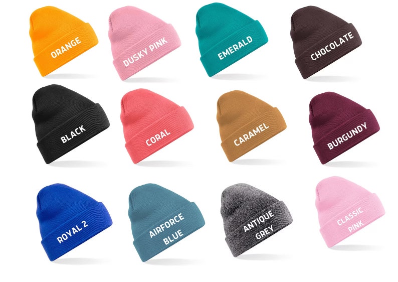 May include: A collection of twelve beanies in various colors, including orange, dusky pink, emerald, and chocolate. Each beanie has a folded cuff and a white text label indicating its color, such as "Orange" and "Black".