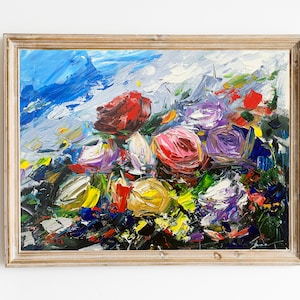 May include: A framed abstract oil painting featuring a colorful bouquet of flowers in shades of red, pink, purple, yellow, and white. The background is a blue and white abstract sky.