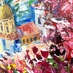 May include: A colorful oil painting of a cityscape with a church dome in the foreground. The painting features a mix of red, blue, yellow, and white colors, with a focus on the church dome and its intricate details.