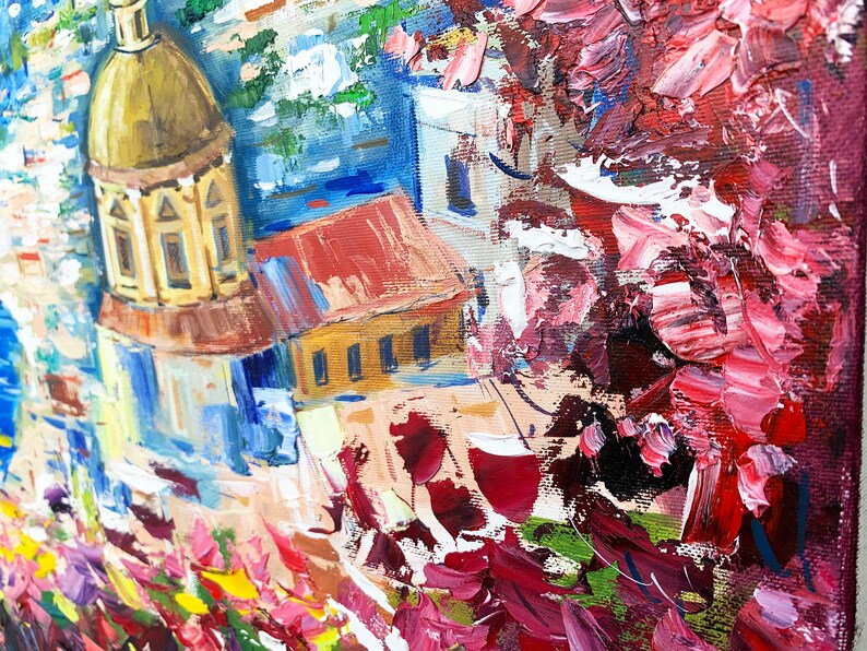 May include: A colorful oil painting of a cityscape with a church dome in the foreground. The painting features a mix of red, blue, yellow, and white colors, with a focus on the church dome and its intricate details.