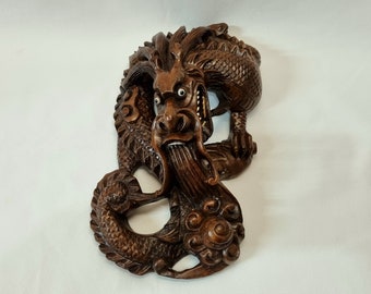 Antique dragon figurine - an attractive hand carved hardwood Chinese three claw dragon wall hanging sculpture with bovine bone eyes & teeth.