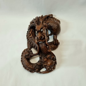 Antique dragon figurine - an attractive hand carved hardwood Chinese three claw dragon wall hanging sculpture with bovine bone eyes & teeth.