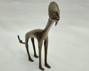 African bronze creature - a bizarre vintage African bronze heavily stylised animal with a giraffe type body and a flat human-like face.