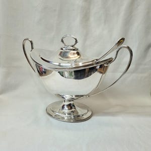 A huge and imposing Adam style antique silver plated tureen and ladle by William Hutton & Sons(s), designed in the Regency style of c.1810