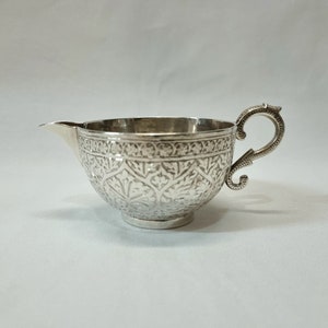 Antique Kashmiri silver jug with finely worked chased decoration, Indian creamer, early 20th century solid silver milk jug weighing 130g.