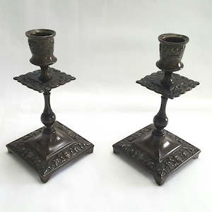 Vintage bronze candlesticks - an attractive pair of Victorian style bronze patinated candlesticks with faun heads on each side of the plinth