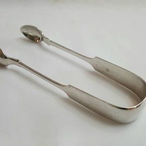 Silver sugar tongs - a pair of Victorian silver sugar tongs, by Josiah Williams & Co, hallmarked for the EXETER Assay Office, 1866, 64g.