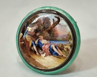 A George V Art Deco hallmarked sterling silver compact with enamel pictorial lid and guilloche enamel case in good condition, dated 1927