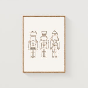 May include: A printable art print featuring three nutcracker soldiers in a minimalist line drawing style. The nutcrackers are outlined in brown and are set against a white background.
