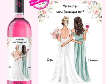 May include: A pink wine bottle with a personalized label featuring two women, one in a white wedding dress and the other in a teal bridesmaid dress. The label says "Möchtest du meine Trauzeugin sein?" which translates to "Would you be my maid of honor?" The names "Sofie" and "Hannah" are also on the label.