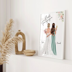 Puede incluir: Impresi&oacute;n art&iacute;stica enmarcada con dos mujeres en vestidos, uno blanco y otro verde azulado, con el texto "Beste Trauzeugin" y los nombres "Sofie" y "Hannah". La obra est&aacute; decorada con detalles florales.