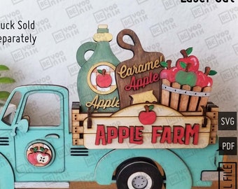 May include: A teal blue toy truck with a wooden bed carrying a sign that says "Apple Farm". The truck is decorated with apples, a caramel apple sign, and a jug of apple cider. The truck is a laser cut file.