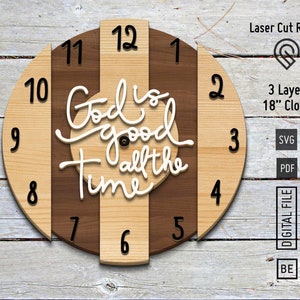 May include: A three-layer wooden clock with a brown and beige striped design. The clock face features the text "God is good all the time" in white lettering. The clock is 18 inches in diameter.