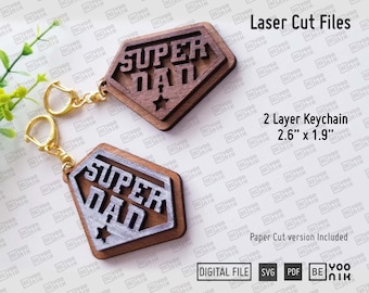 May include: Two-layer wooden keychain with a silver and brown "Super Dad" design. The keychain is 2.6 inches by 1.9 inches and includes a paper cut version.