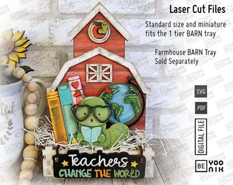 May include: A red wooden schoolhouse with a green worm on the roof, a globe, books, and a green turtle holding a book. The schoolhouse is in a wooden crate with the text "Teachers Change The World" on the front. The image is for laser cut files.