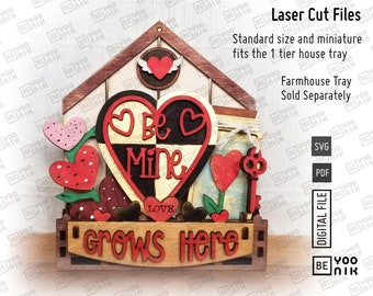 May include: Laser cut file design of a wooden house with a heart that says "Be Mine" and a sign that says "Love Grows Here". The design is perfect for Valentine's Day or a wedding.
